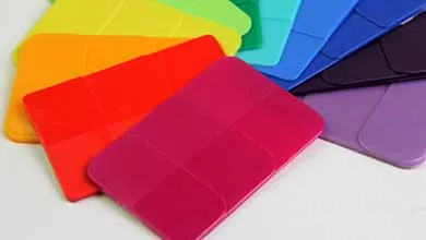 Colorful plastic card holders in red, orange, green, blue, and purple are fanned out on a white surface.