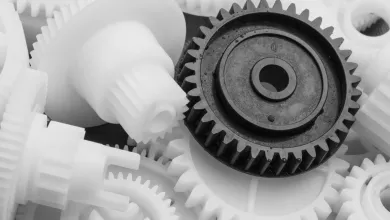 Close‑up of white and black plastic gears interlocked together.