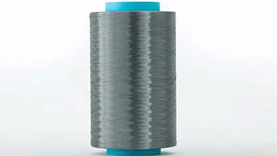 A spool of shiny gray thread with a turquoise center on a white background.