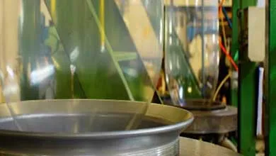 Close-up of a blown film production line showing polyethylene film being processed on industrial equipment used for heavy-duty bag manufacturing.